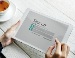 a person trying to sign up for a service using ipad