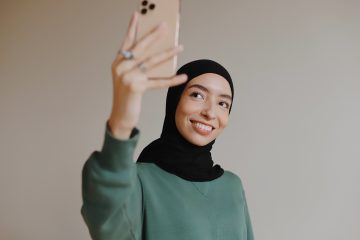 A woman take a selfie with her phone.